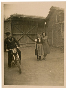 two women and a young man on a motorcycle - circa 1950