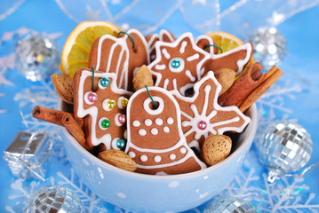 bowl of homemade christmas gingerbread cookies on blue backgroun