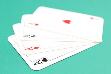 Composition of four aces on green background