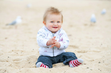 Little Kid on Sand Beach and Seagulls