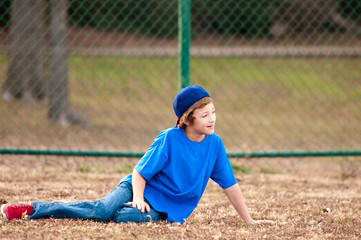 Cute boy sitting on grass