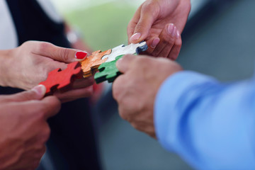 Group of business people assembling jigsaw puzzle