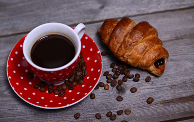 Coffee and croissant on wooden