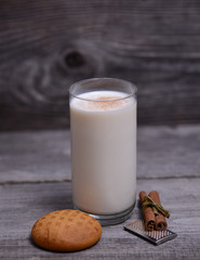Glass of milk with cinnamon and gingerbread