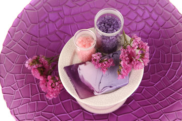 Hand made soap with sea salts on purple plate close-up