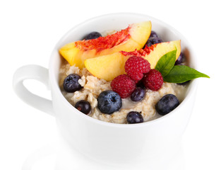 Oatmeal in cup with berries isolated on white