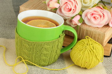 Cup of tea with knitted thing on it close up