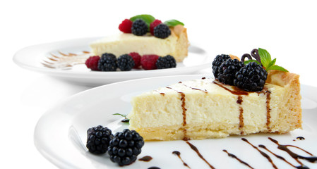Slices of cheesecakes on plate, close-up