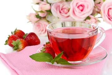 Delicious strawberry tea on table close-up