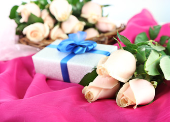 Fototapeta na wymiar Beautiful bouquet of roses, on fabric, on light background