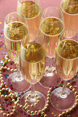 Glasses with champagne on shiny background