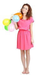 Fototapeta premium Smiling young woman in pink dress holding colorful balloons, celebrating party and happiness, isolated on white background
