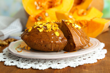 Delicious pumpkin pie on plate on wooden table close-up