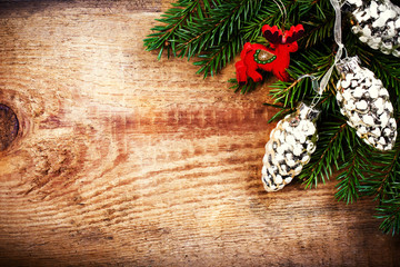 Christmas Tree Branch on wooden background with wood deer and si