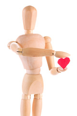 Wooden mannequin holding red heart isolated on white