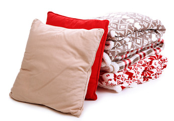 Warm plaids and pillows isolated on white