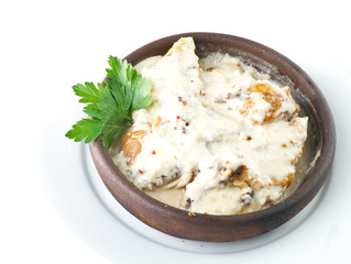 stew chicken in a creamy sauce with mushrooms