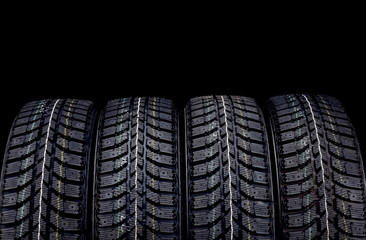 Winter car tires on black background