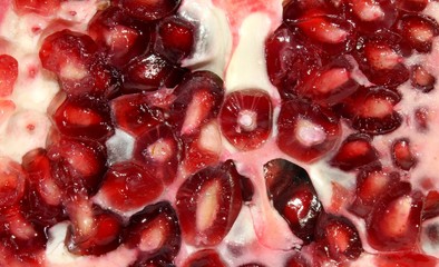 macro of a ripe pomegranate red with juicy seeds