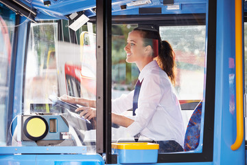 Portrait Of Female Bus Driver Behind Wheel © Monkey Business