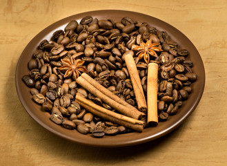 Coffee beans in ceramic plate with spices
