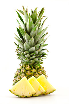 half pineapple and slices on a white background