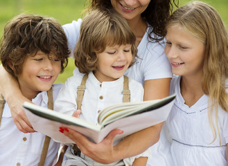 Fototapeta na wymiar Mother and kids reading a book