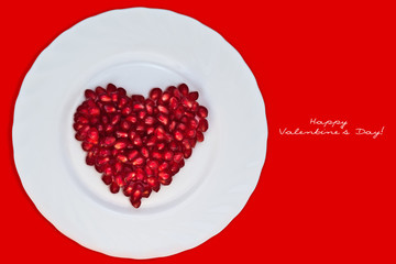 Heart of pomegranate on a white plate