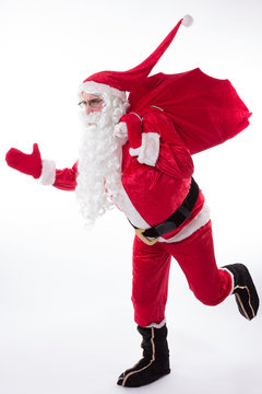 Santa Claus running with the bag isolated on white background
