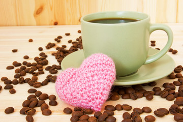cup of coffee and pink knitted valentine's heart