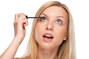 Portrait of teenage girl applying mascara