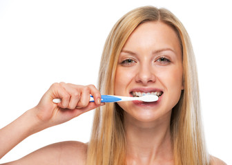 Portrait of teenage girl brushing teeth