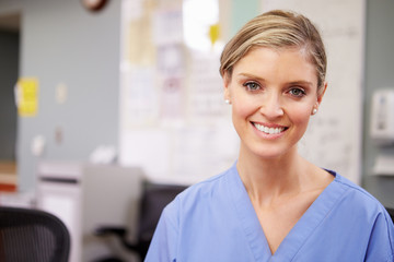 Portrait Of Female Nurse Working At Nurses Station