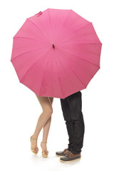 Female and man's legs under a umbrella
