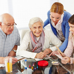 Family with senior couple playing games