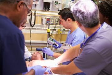 Medical Team Working On Patient In Emergency Room