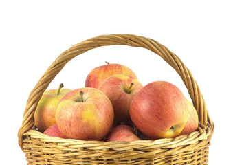Red and yellow ripe apples in wicker basket isolated close up