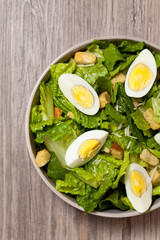 Caesar salad with eggs, lettuce, croutons and parmesan