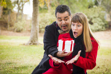 Mixed Race Couple Sharing Christmas or Valentines Day Gift Outsi