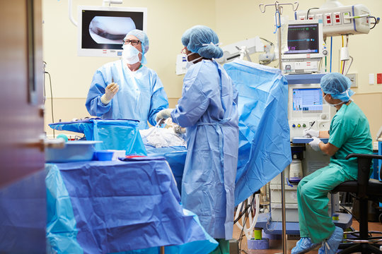 Surgical Team Working In Operating Theatre