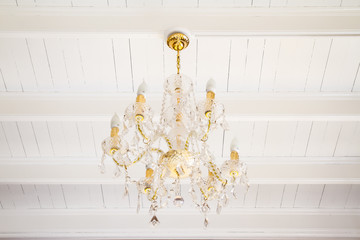 Crystal chandelier on wooden ceiling