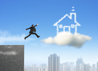 Businessman running and jumping on cloud dream house