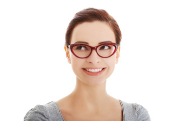 Portrait of beautiful woman in eyeglasses looking up.