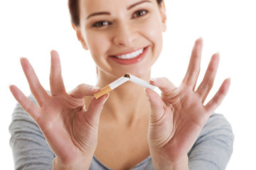 Young beautiful woman holding broken cigarette.