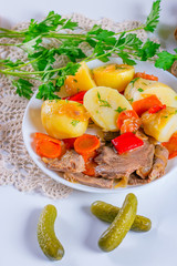 Stew meat with carrots, peppers, onions, potato and pickled cucu