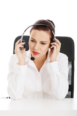 Beautiful woman sitting with microphone and headphones.