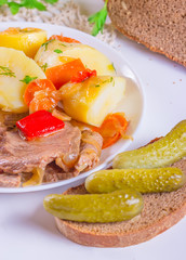 Stew meat with carrots, peppers, onions, potato and pickled cucu