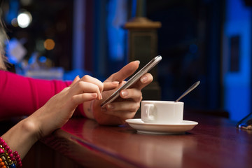 close-up of female hands holding a cell phone