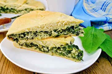 Pie with spinach and cheese on the board
