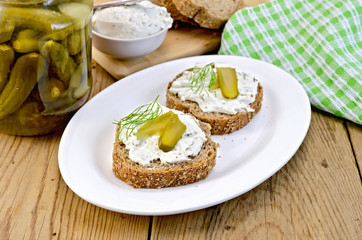 Sandwich with cream and pickles on a board